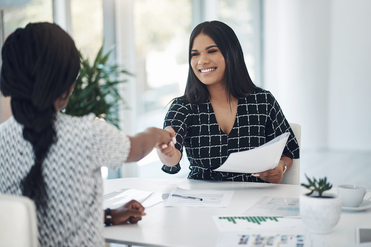 A woman meets with a financial advisor to discuss charitable tax deductions.