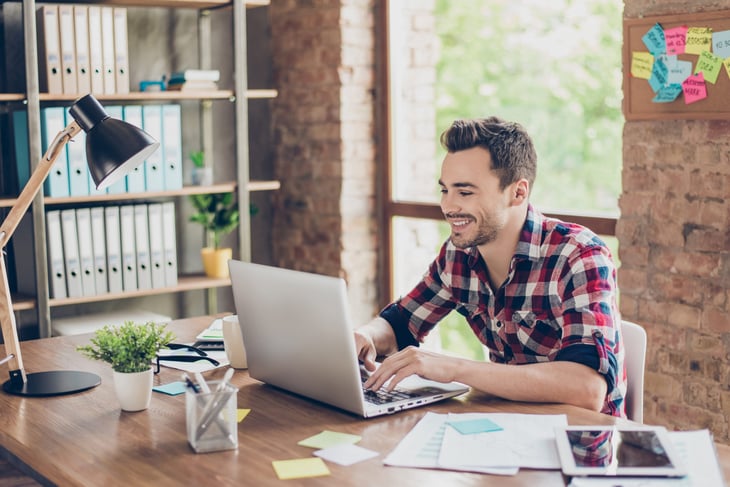 Man working in home office on laptop
