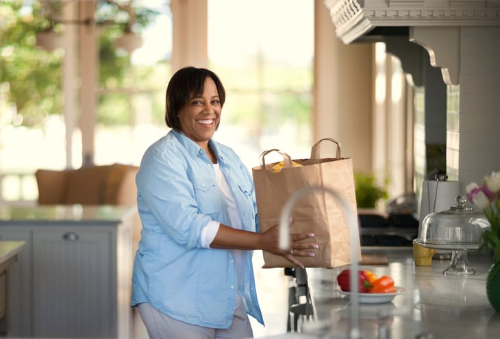 Woman putting away groceries